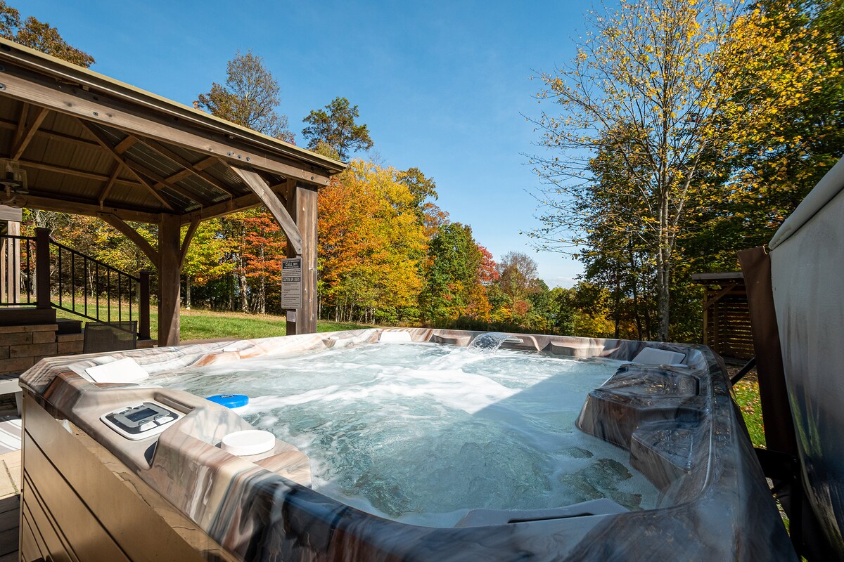 Outdoor hot tub surrounded by autumn trees
